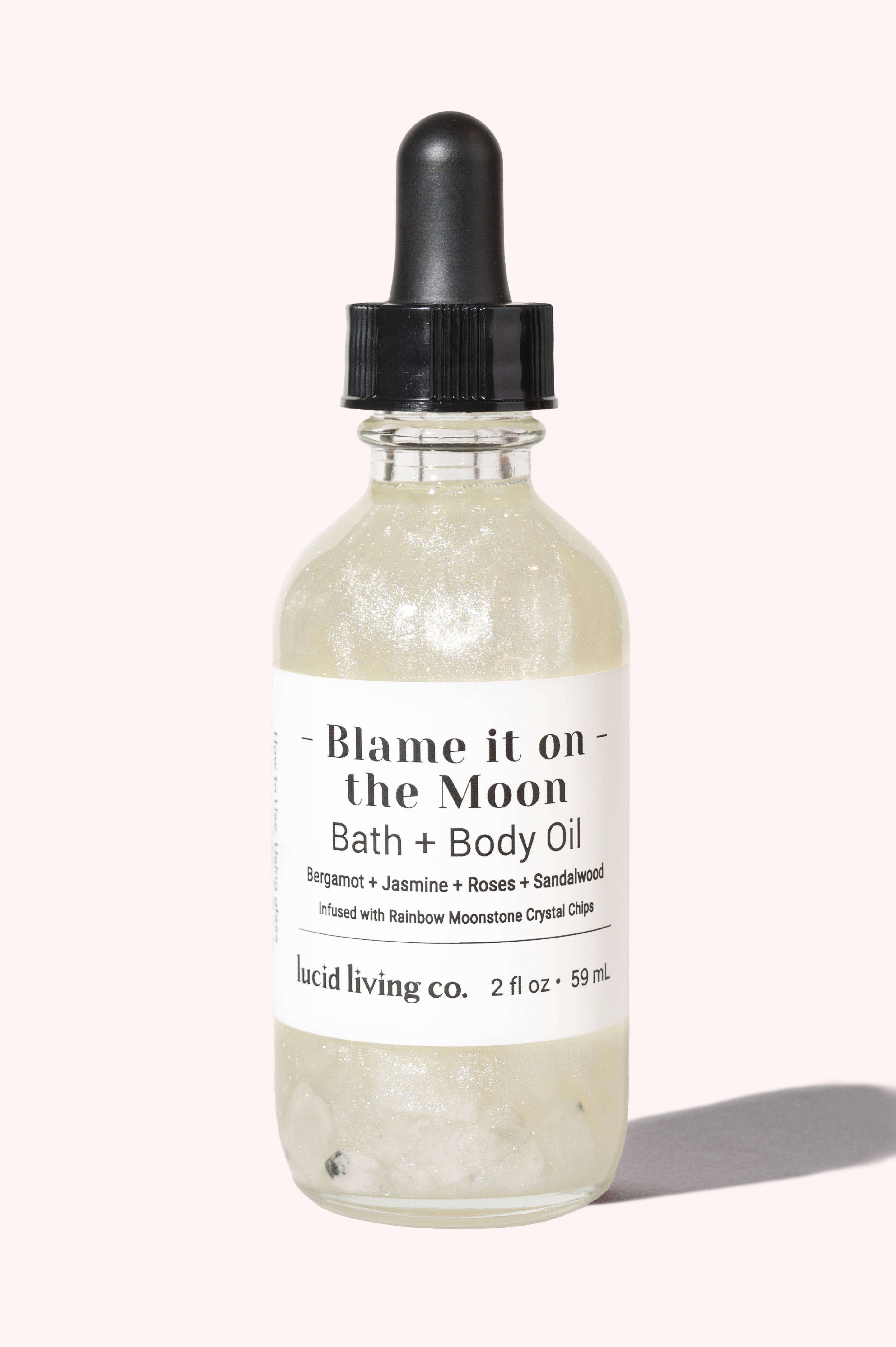 Blame it on the Moon Bath & Body Oil with bergamot, jasmine, rose, sandalwood, and rainbow moonstone chips.