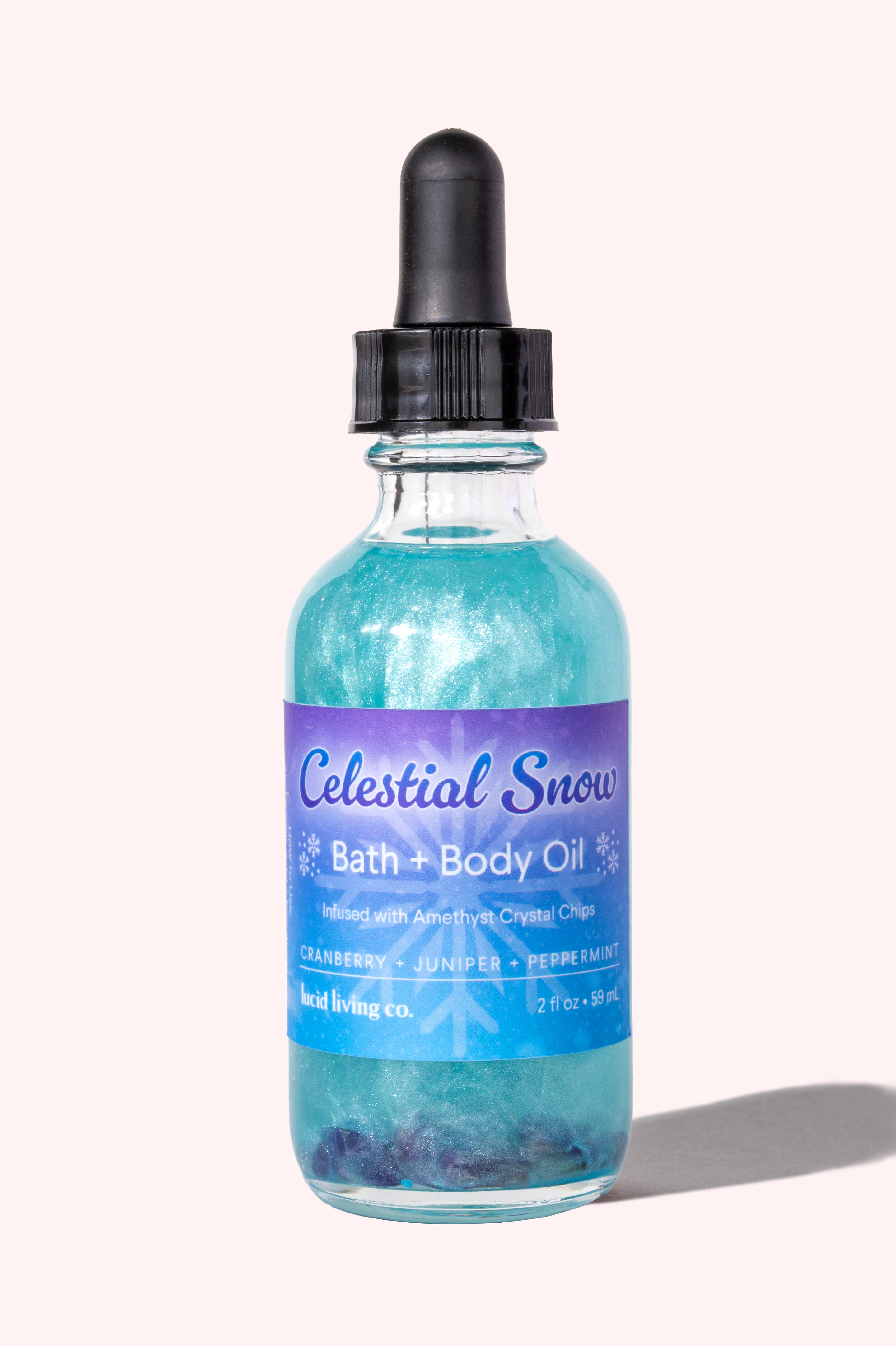Celestial Snow Bath & Body Oil with cranberries, juniper, peppermint, and amethyst crystal chips for soothing skin.