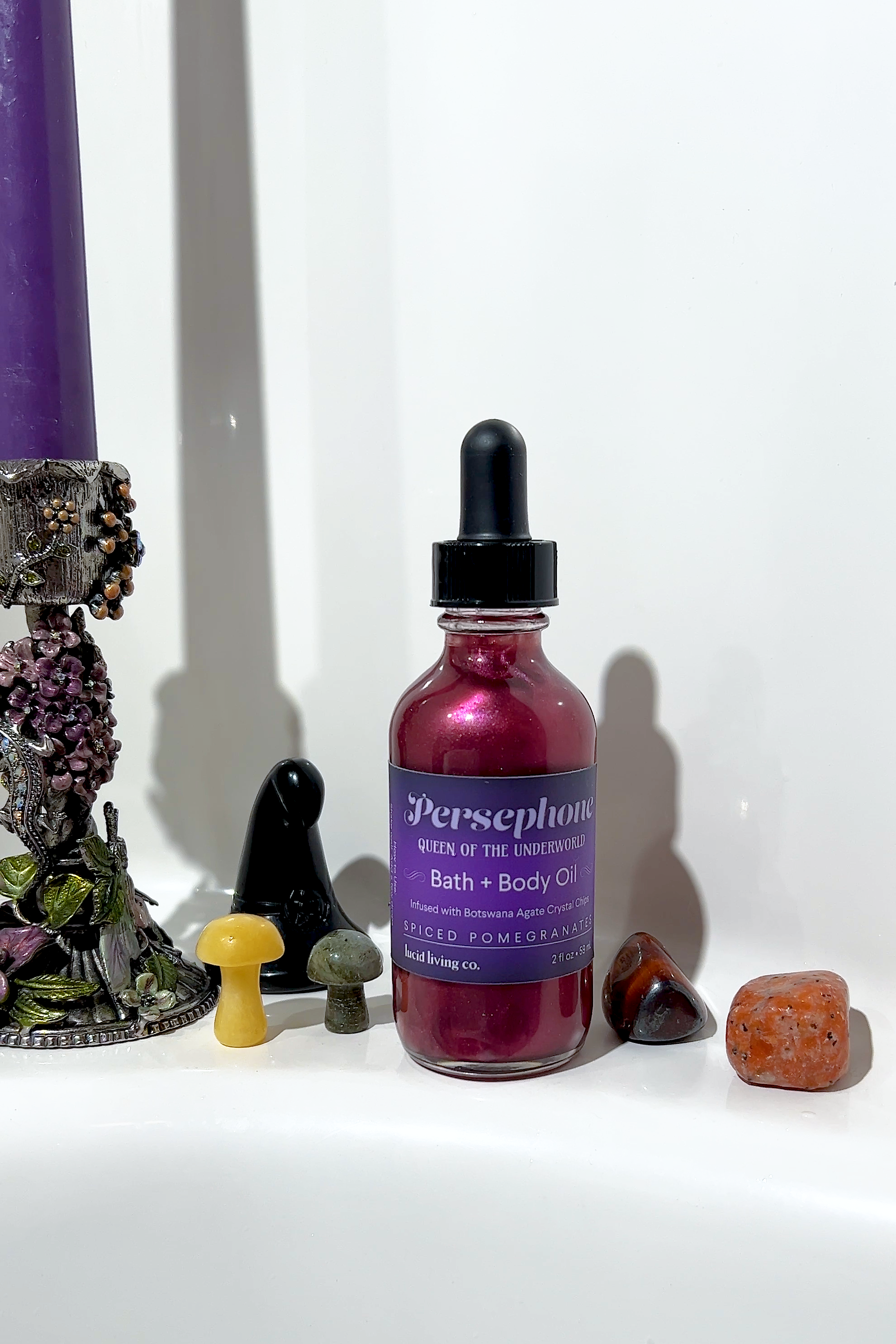 Persephone Bath & Body Oil bottle with spiced pomegranate and Botswana Agate crystal chips by lucid living co.