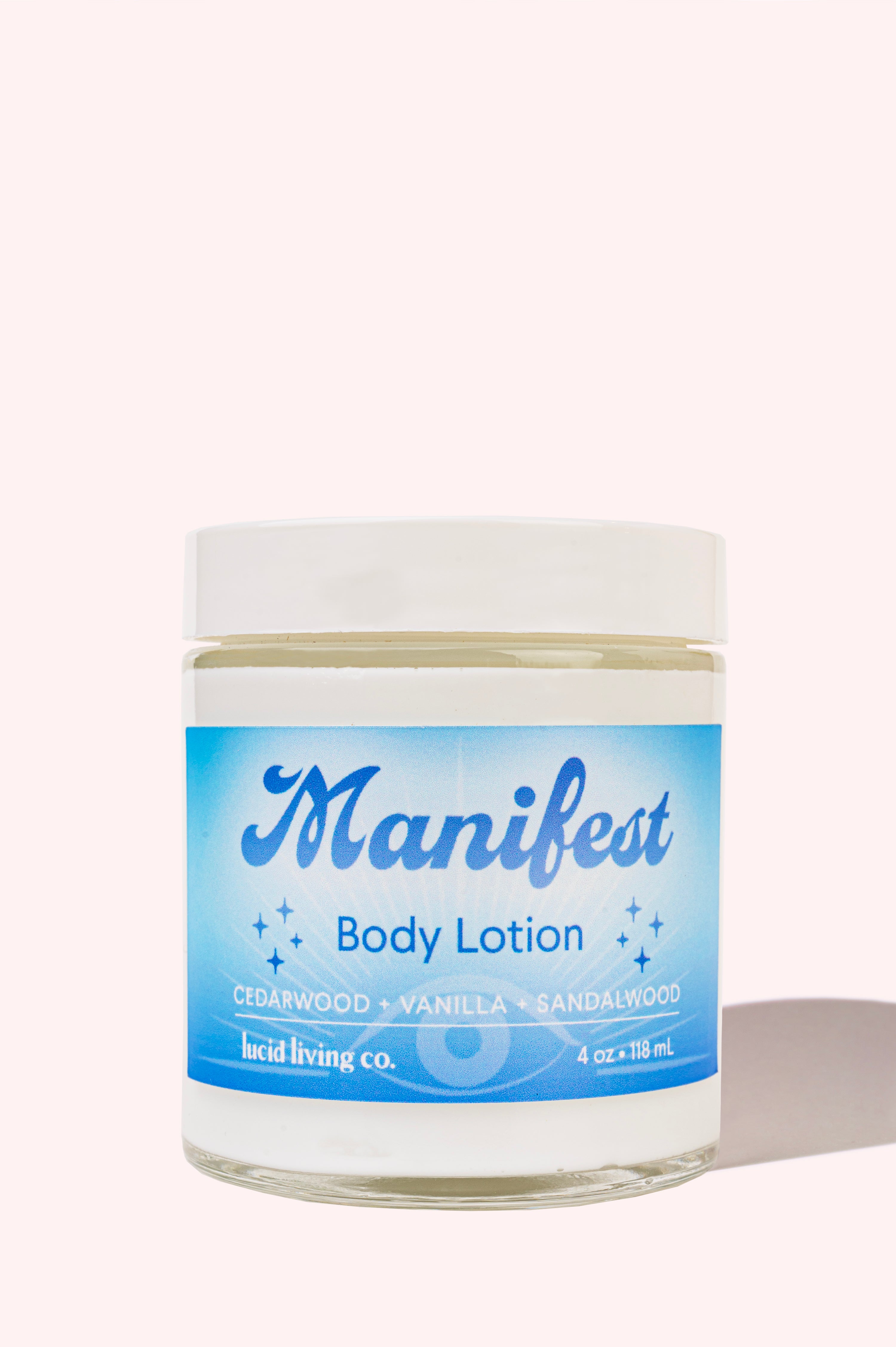 Manifest Body Lotion in a jar with cedarwood, vanilla, and sandalwood fragrance for hydrated, soft skin.