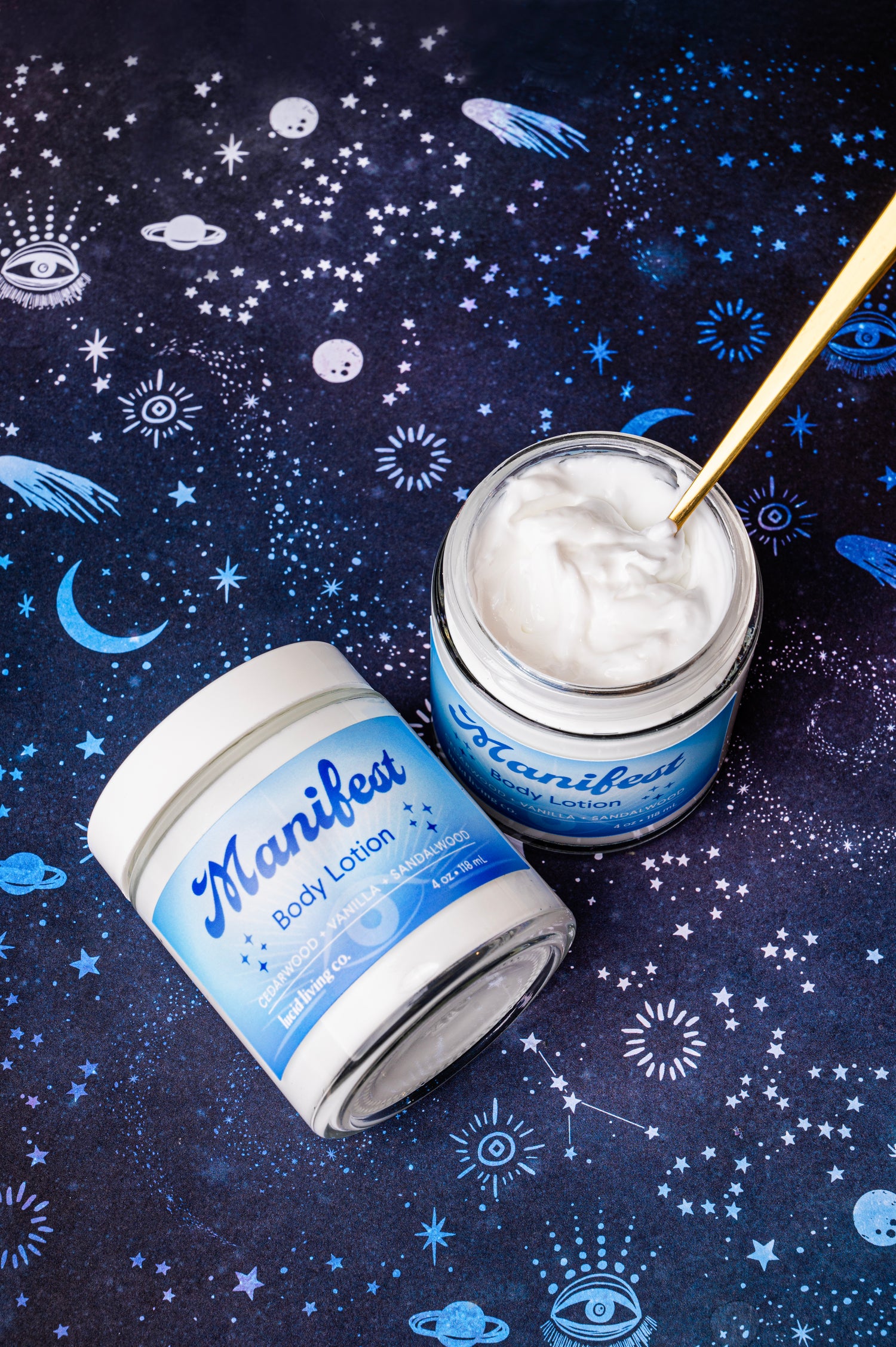 Manifest Bundle showing two jars of body lotion with a celestial starry night background.