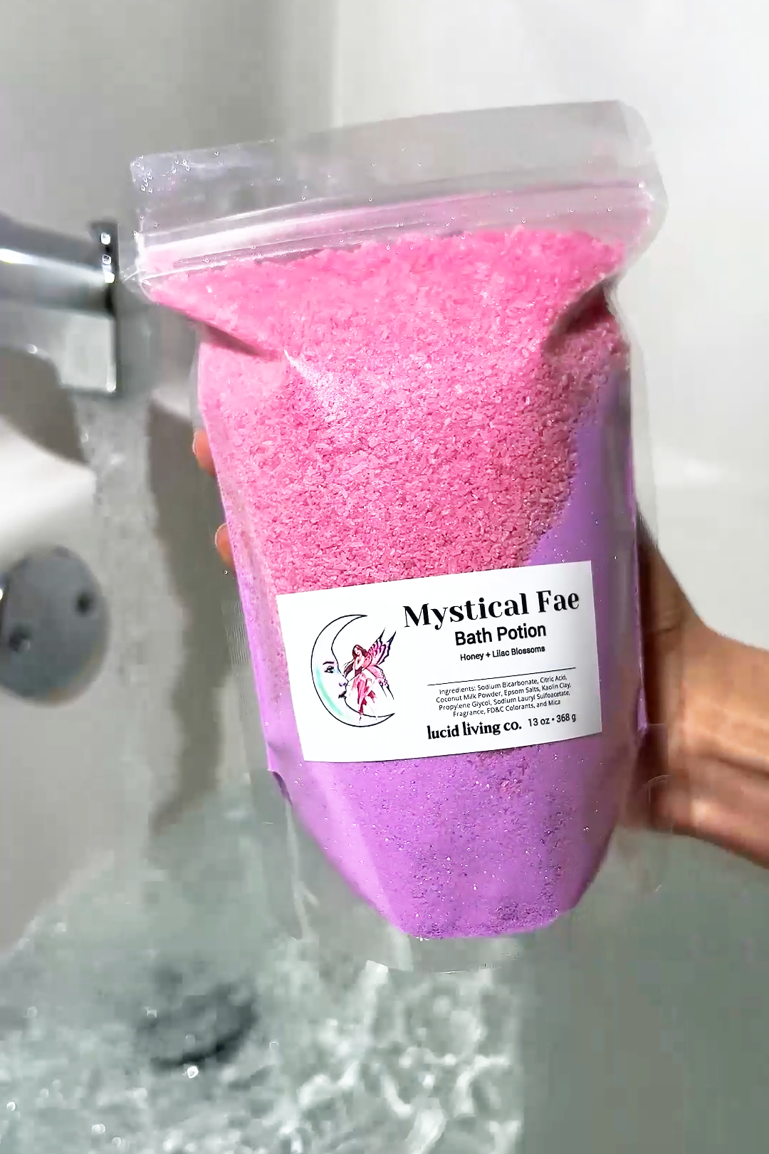Mystical Fae Bath Potion with honey and lilac scent, soothing pink and purple bath salts in resealable bag.