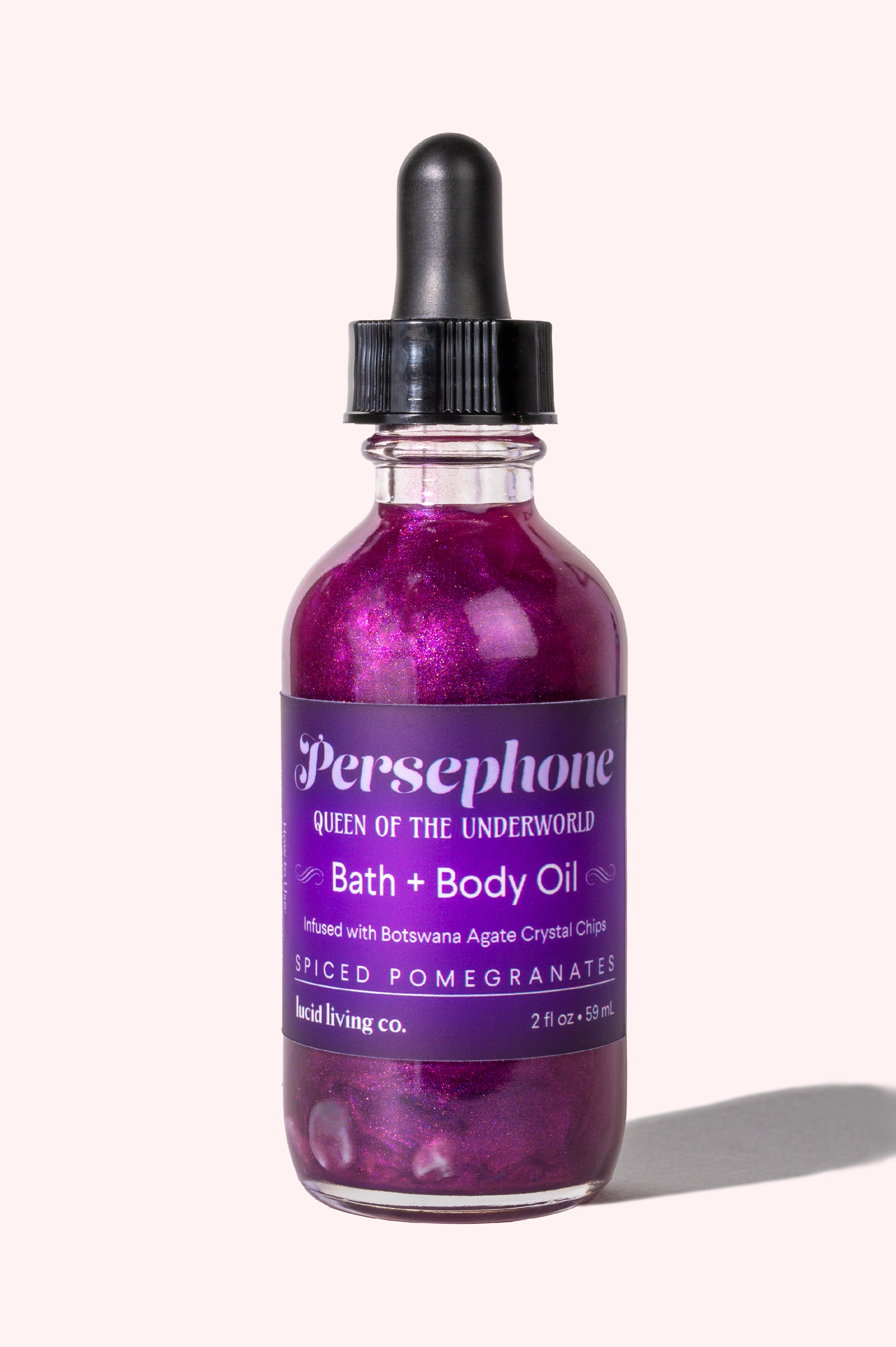 Persephone Bath & Body Oil with spiced pomegranate and Botswana Agate crystal chips for emotional balance.