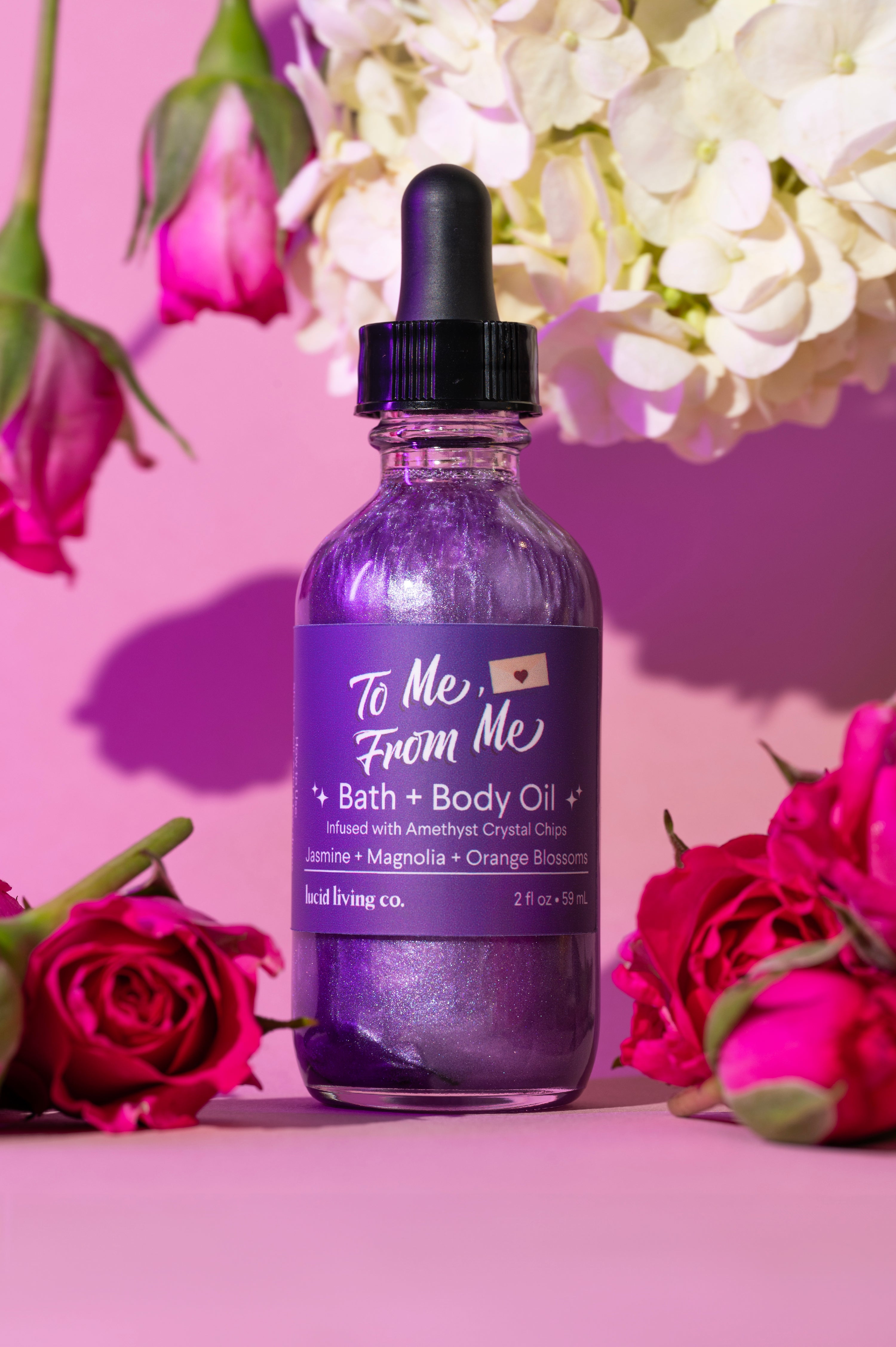 To Me, From Me Bath & Body Oil with amethyst chips, jasmine, magnolia, and orange blossom floral scents.