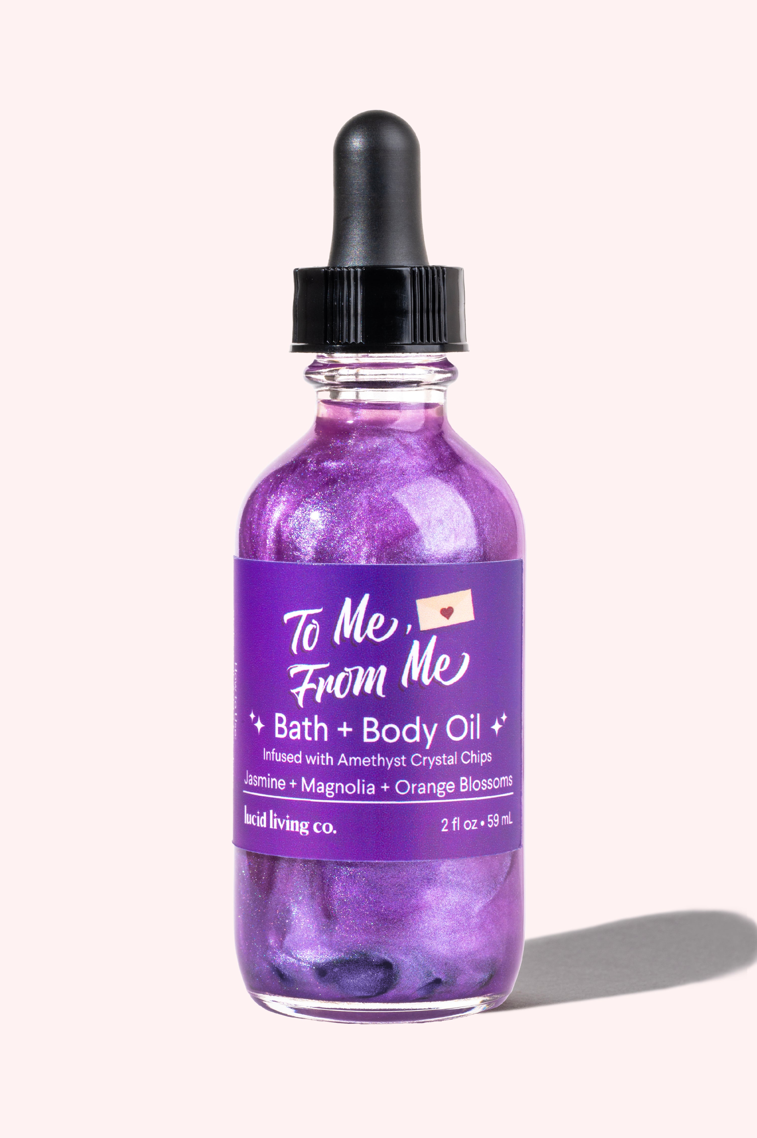 To Me, From Me Bath & Body Oil in a purple shimmer with amethyst chips and floral scents for self-care.