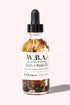 W.B.A. Witch Bitch Autumn Bath & Body Oil with pumpkin spice, caramel, ginger, cinnamon, and crystal chips in a clear bottle.