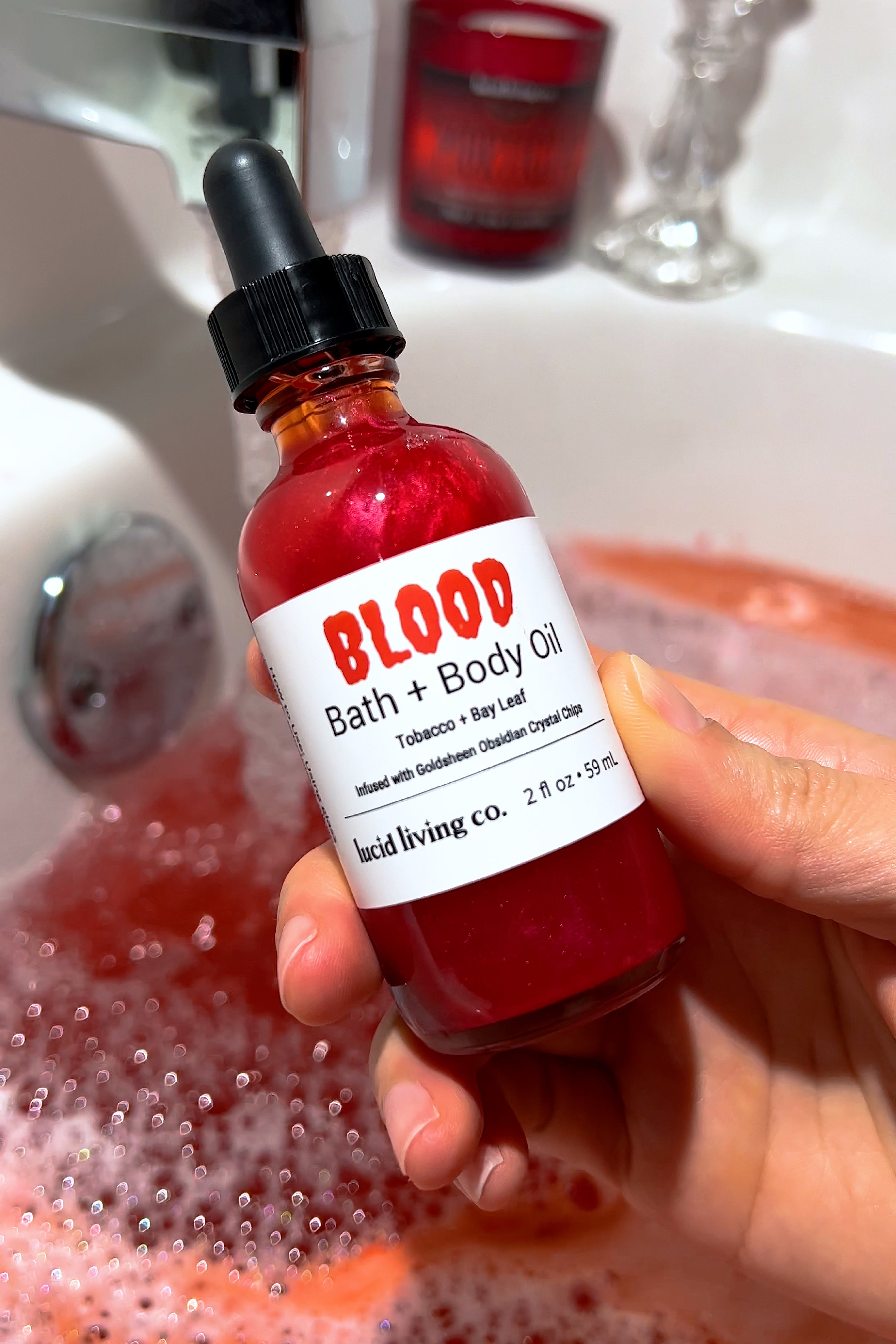 BLOOD Bath & Body Oil with smoky tobacco and bay leaf scent, infused with Goldsheen Obsidian crystal chips.