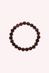 Garnet Crystal Bracelet featuring polished deep red beads arranged in a circular stretch design, highlighting the natural beauty and rich tones of garnet gemstones against a soft pale background.